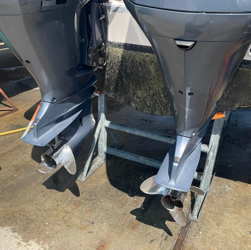 Slide: The Image of Twin outboard motors on a 2006 Grady-White Bimini 306 boat, displayed on a stand. - 18