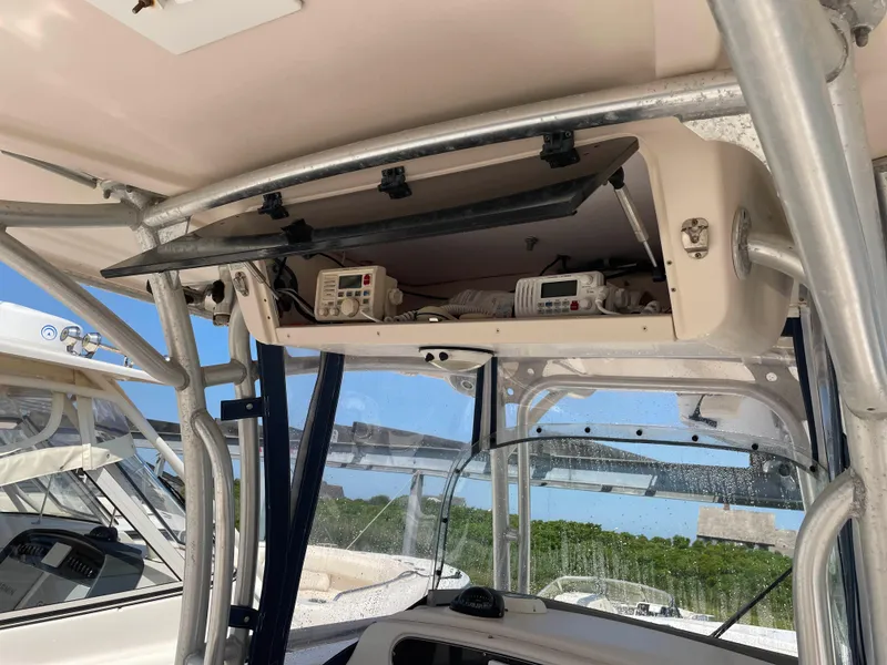 Slide: The Image of 2006 Grady-White Bimini 306 boat electronics compartment with open storage and equipment. - 19