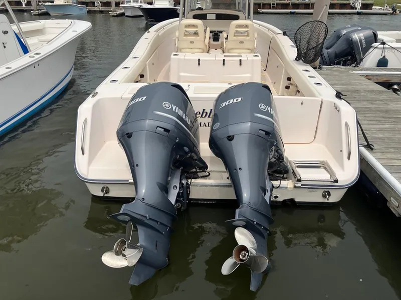 Slide: The Image of 2006 Grady-White Bimini 306 boat with twin Yamaha 300 engines docked at marina. - 2