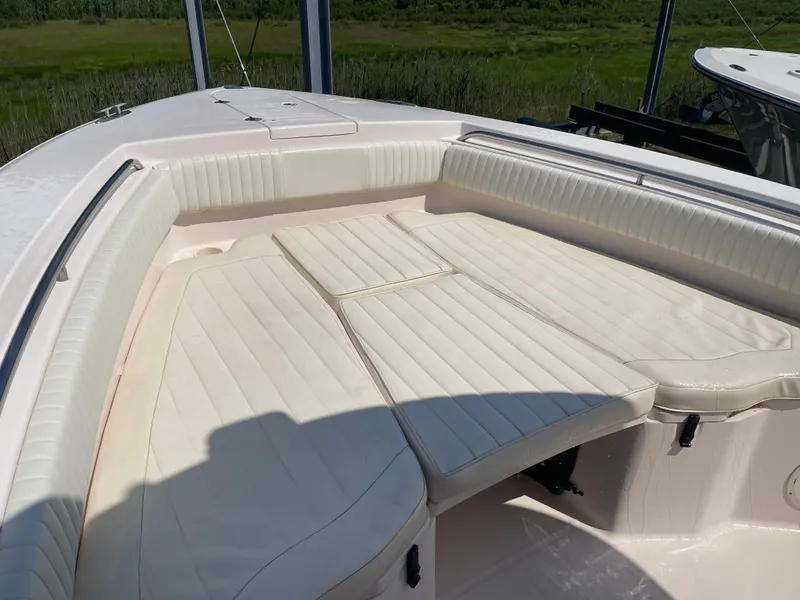 Slide: The Image of 2006 Grady-White Bimini 306 boat interior with cushioned seating in sunlight. - 21