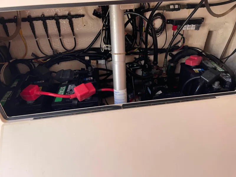 Slide: The Image of 2006 Grady-White Bimini 306 boat battery compartment with wiring and connections. - 22
