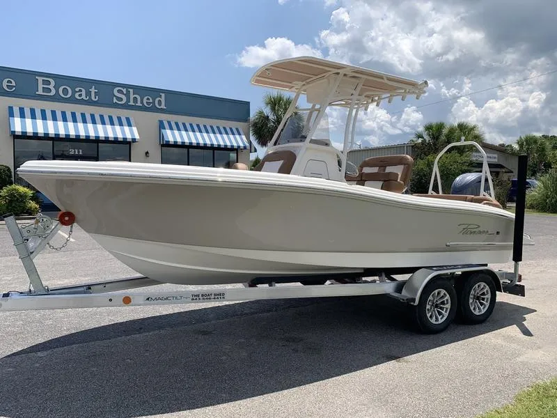 Slide: The Image of 2026 Pioneer ISLANDER 202 boat on trailer outside The Boat Shed dealership. - 1
