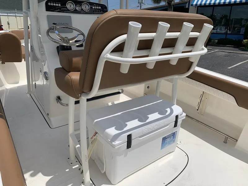 Slide: The Image of 2026 Pioneer ISLANDER 202 boat interior with helm, rod holders, and cooler. - 10
