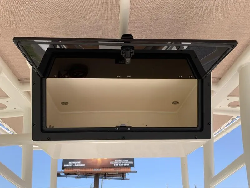 Slide: The Image of 2026 Pioneer ISLANDER 202 boat compartment with open hatch, showcasing interior details. - 14