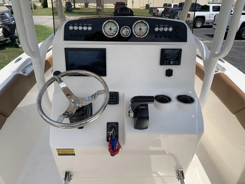 Slide: The Image of 2026 Pioneer ISLANDER 202 boat console with steering wheel, gauges, and controls. - 15