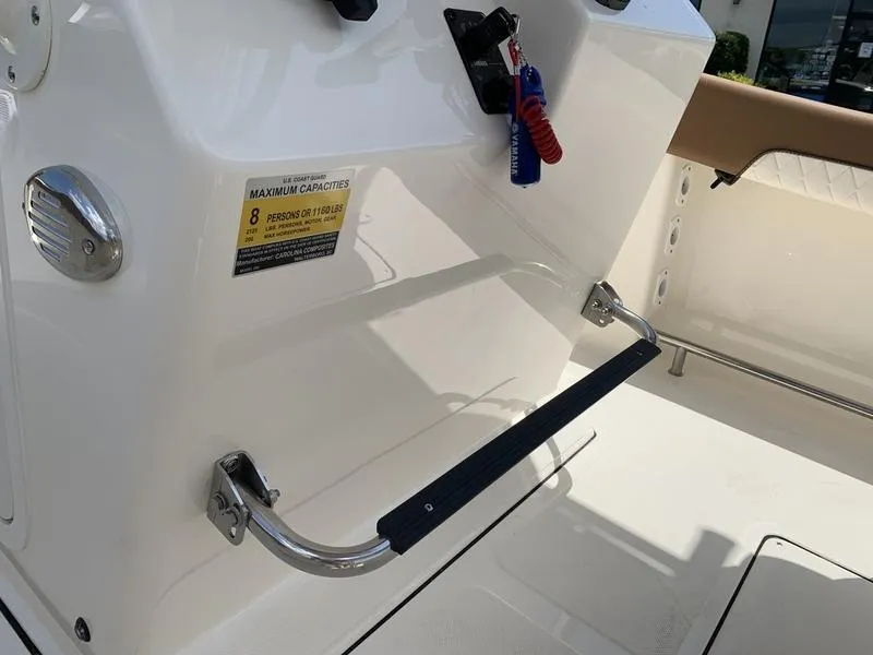 Slide: The Image of 2026 Pioneer ISLANDER 202 boat interior, showing seating and capacity label for 8 persons. - 16