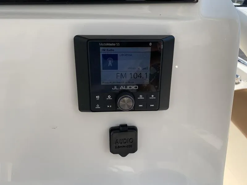 Slide: The Image of JL Audio MediaMaster 55 on Pioneer ISLANDER 2026, displaying FM 104.1 radio station. - 18