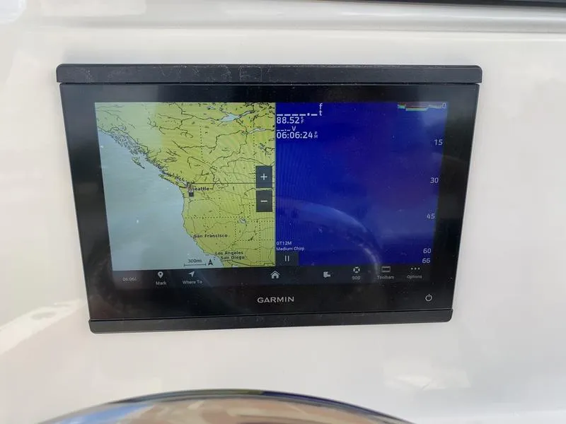 Slide: The Image of Garmin navigation display on Pioneer ISLANDER 202 boat, showing coastal map and depth data. - 19