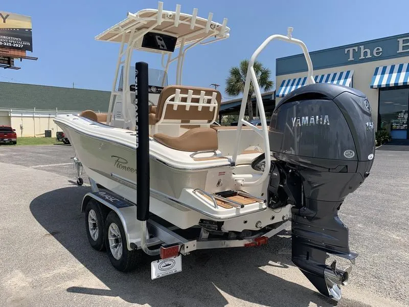 Slide: The Image of 2026 Pioneer ISLANDER 202 boat with Yamaha engine on trailer, parked outdoors. - 2