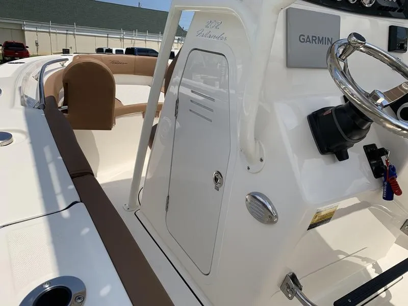 Slide: The Image of 2026 Pioneer ISLANDER 202 boat interior with Garmin system and brown seating. - 23