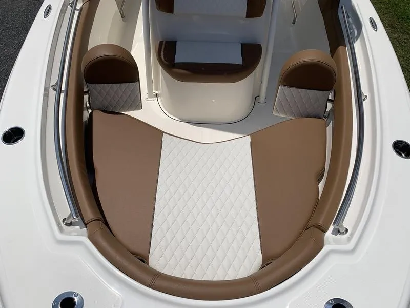 Slide: The Image of 2026 Pioneer ISLANDER 202 boat interior with brown and white cushioned seating. - 28