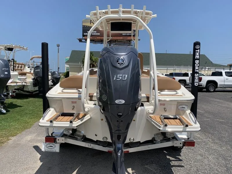 Slide: The Image of 2026 Pioneer ISLANDER 202 boat with Yamaha 150 outboard motor, parked outdoors. - 3