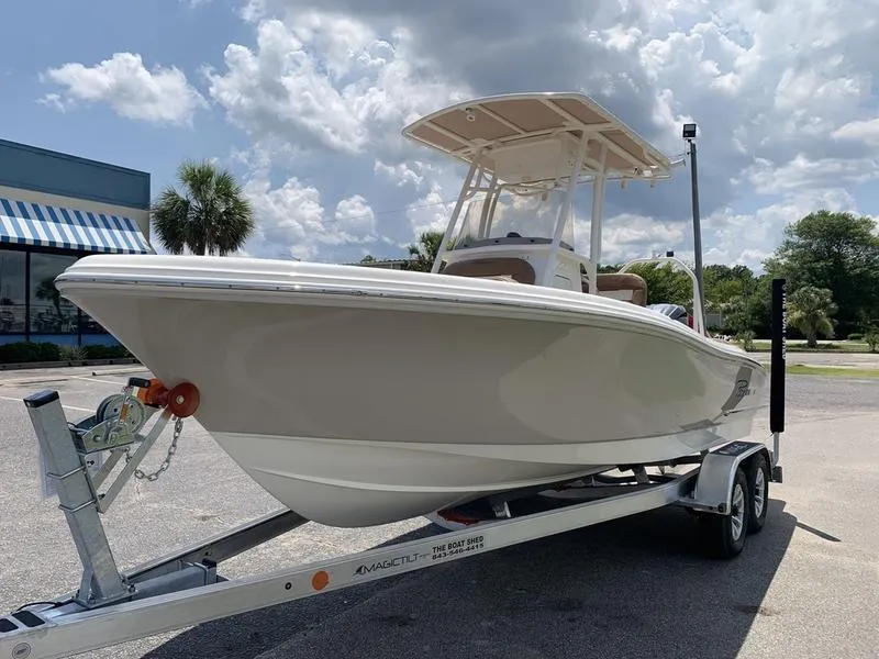 Slide: The Image of 2026 Pioneer ISLANDER 202 boat on trailer under cloudy sky. - 8
