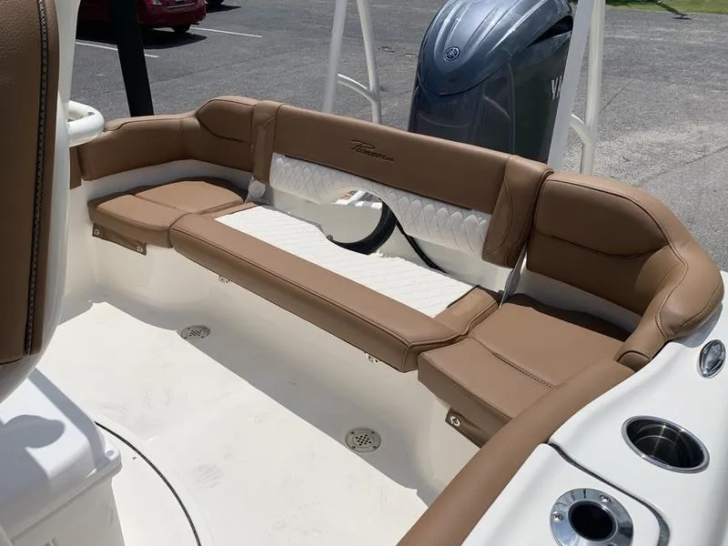 Slide: The Image of 2026 Pioneer ISLANDER 202 boat interior with tan seating and cup holders. - 9