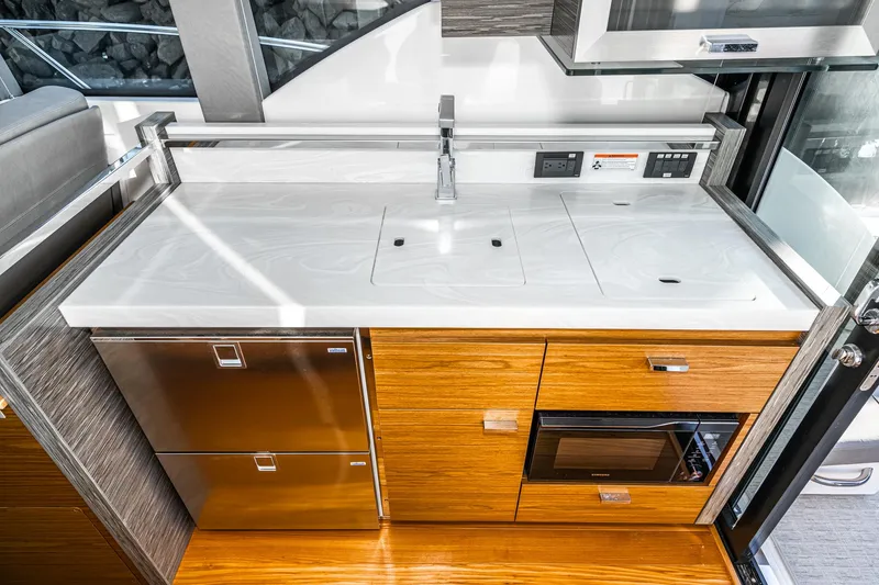 Slide: The Image of Modern kitchen area in 2020 Tiara Yachts 39 Coupe with sleek cabinetry and appliances. - 11