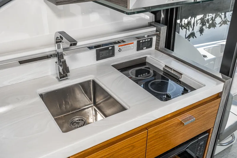 Slide: The Image of Modern kitchen area in 2020 Tiara Yachts 39 Coupe with sink and stove. - 14