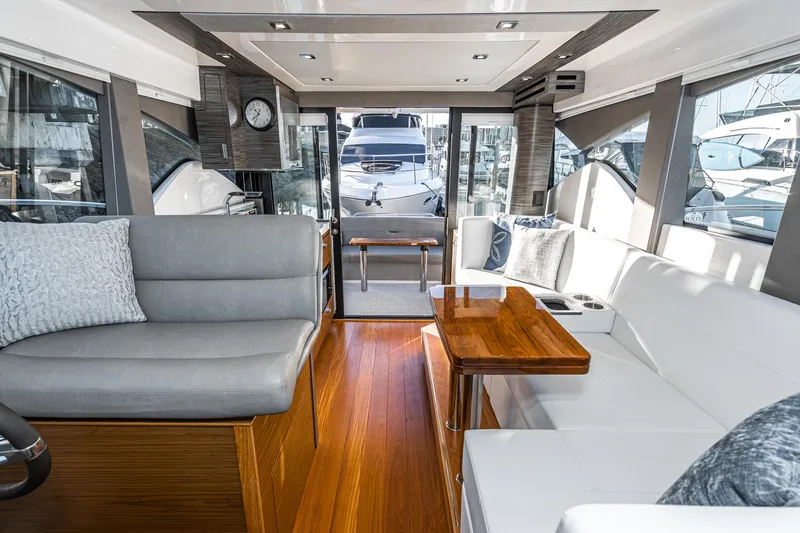 Slide: The Image of Interior of 2020 Tiara Yachts 39 Coupe with elegant seating and wooden accents. - 19