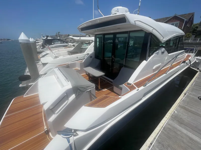 Slide: The Image of 2020 Tiara Yachts 39 Coupe docked, showcasing sleek design and spacious deck. - 2