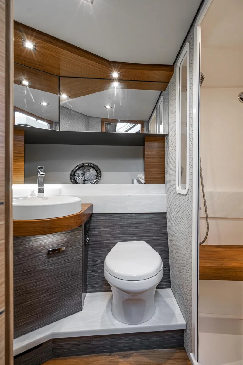 Slide: The Image of Luxurious bathroom in 2020 Tiara Yachts 39 Coupe with modern fixtures and wood accents. - 35