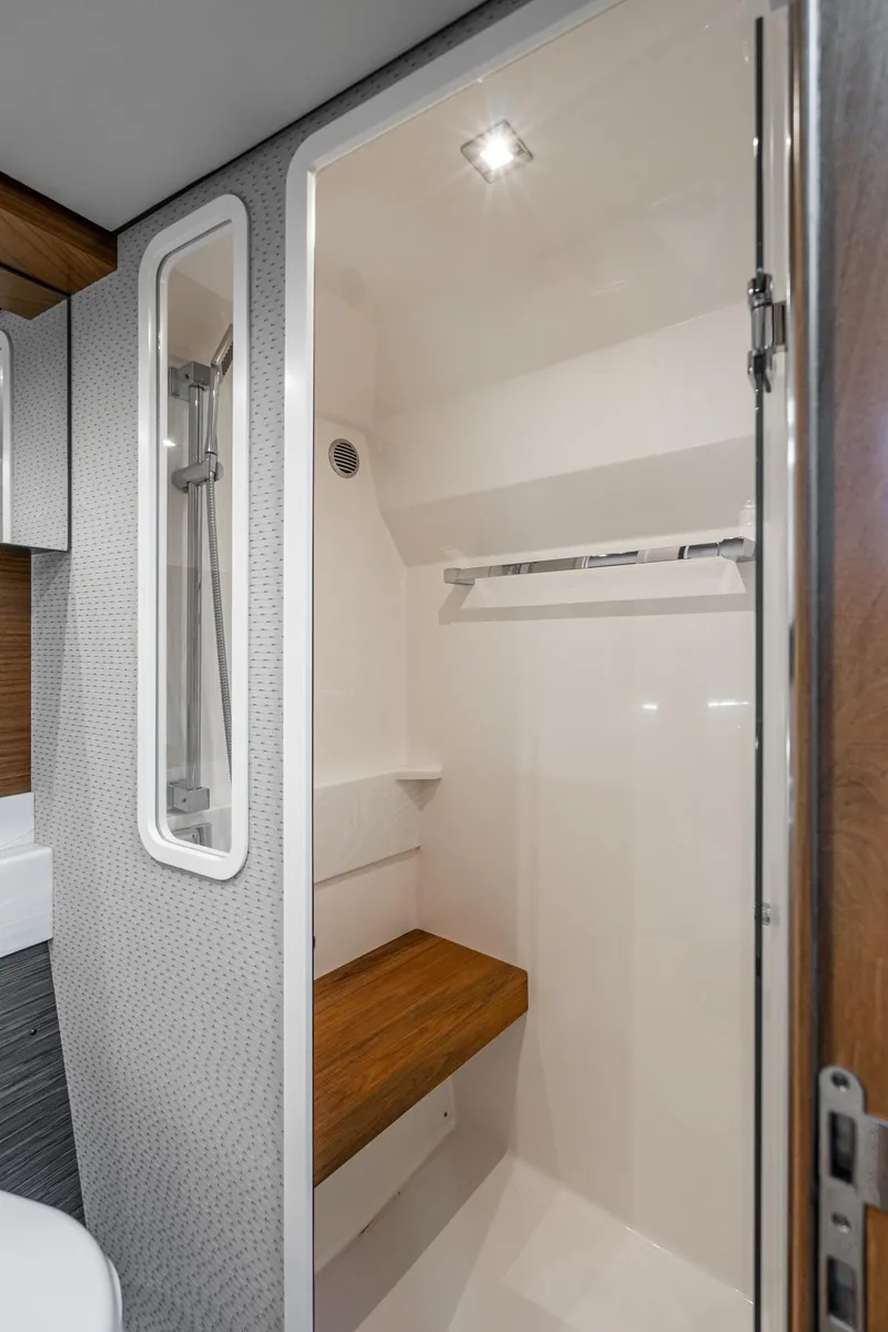 Slide: The Image of 2020 Tiara Yachts 39 Coupe interior shower with wooden bench and modern design. - 36