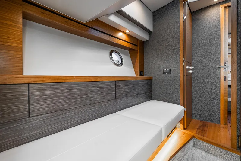 Slide: The Image of 2020 Tiara Yachts 39 Coupe interior with modern wood and white upholstery design. - 40