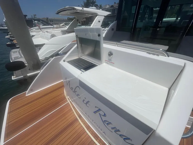 Slide: The Image of 2020 Tiara Yachts 39 Coupe with teak deck and sleek design at marina. - 5