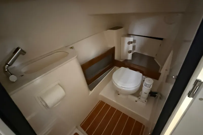 Slide: The Image of Interior of 2026 Grady-White Freedom 285 with toilet and sink. - 16