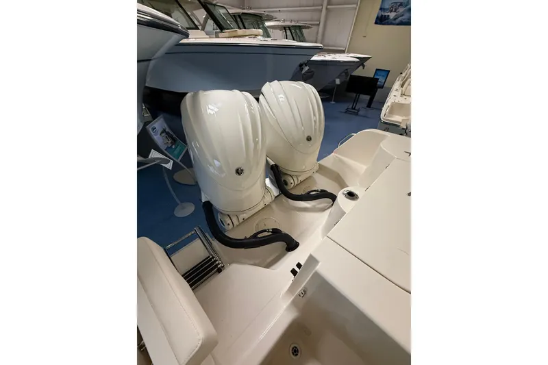 Slide: The Image of 2026 Grady-White Freedom 285 with dual engines in showroom. - 22