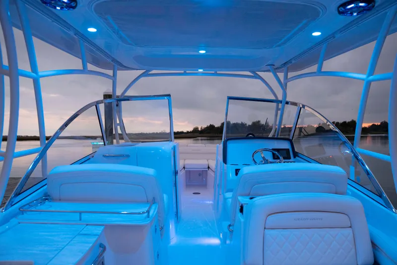 Slide: The Image of 2026 Grady-White Freedom 285 boat interior with blue ambient lighting at dusk. - 4
