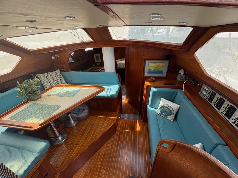 Slide: The Image of 1984 Freedom 39 Pilothouse interior with blue seating, wooden accents, and nautical decor. - 11