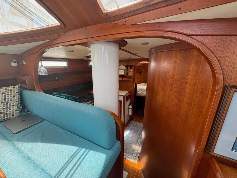 Slide: The Image of Interior of 1984 Freedom 39 Pilothouse yacht with wooden finish and teal seating. - 13
