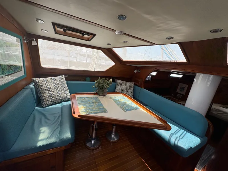 Slide: The Image of Interior of 1984 Freedom 39 Pilothouse with cozy seating and wooden table. - 14