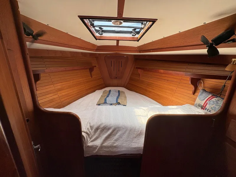 Slide: The Image of Cozy cabin interior of 1984 Freedom 39 Pilothouse sailboat with wooden paneling and skylight. - 20