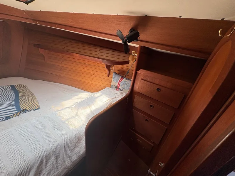 Slide: The Image of Cozy cabin interior of 1984 Freedom 39 Pilothouse with wooden furnishings and bed. - 21