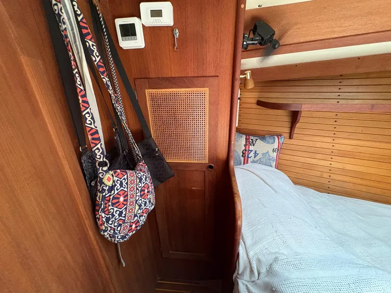 Slide: The Image of Cozy cabin interior of 1984 Freedom 39 Pilothouse with decorative bags and bedding. - 22