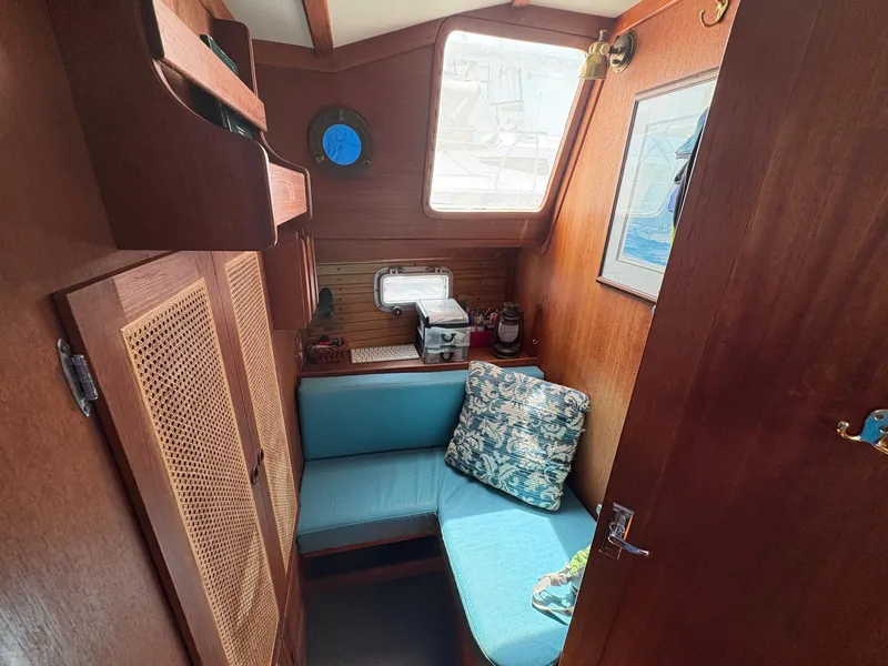 Slide: The Image of Cozy interior of 1984 Freedom 39 Pilothouse with blue seating and nautical decor. - 27