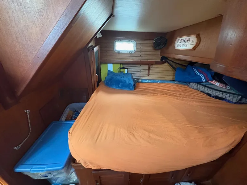 Slide: The Image of Cozy cabin interior of 1984 Freedom 39 Pilothouse with orange bedding and wooden accents. - 29