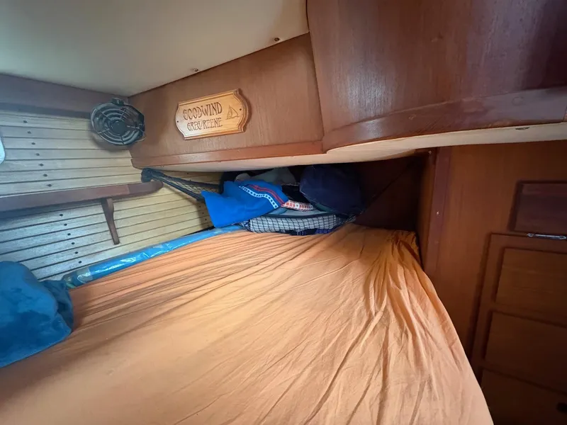 Slide: The Image of Cozy cabin interior of 1984 Freedom 39 Pilothouse sailboat with wooden paneling and bedding. - 30