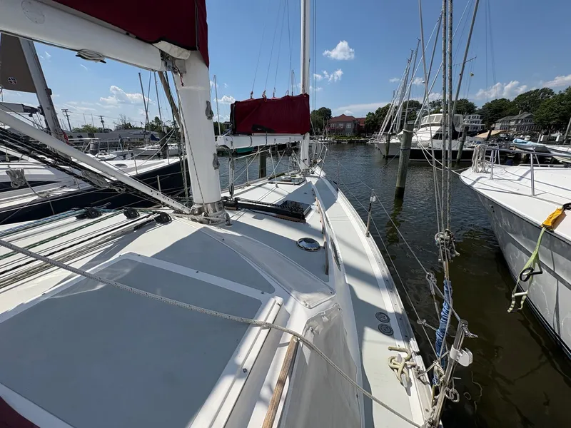 Slide: The Image of 1984 Freedom 39 Pilothouse sailboat docked at marina under clear blue sky. - 35