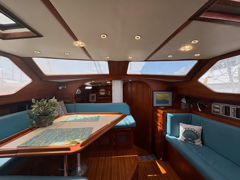 Slide: The Image of Interior of 1984 Freedom 39 Pilothouse sailboat with skylights and blue seating. - 46