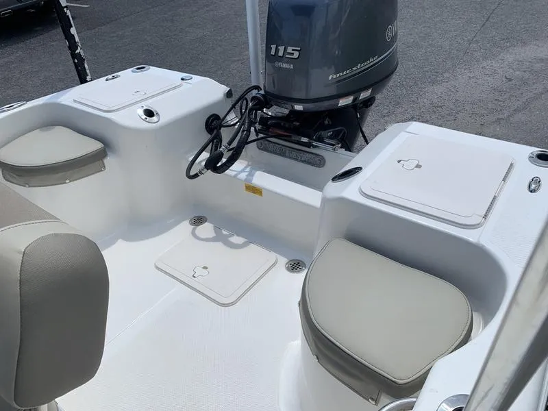 Slide: The Image of 2021 Key West 176cc boat interior with Yamaha 115 engine, featuring cushioned seating and storage compartments. - 10
