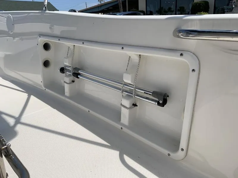 Slide: The Image of 2021 Key West 176cc boat interior detail with rod holders and storage compartment. - 14
