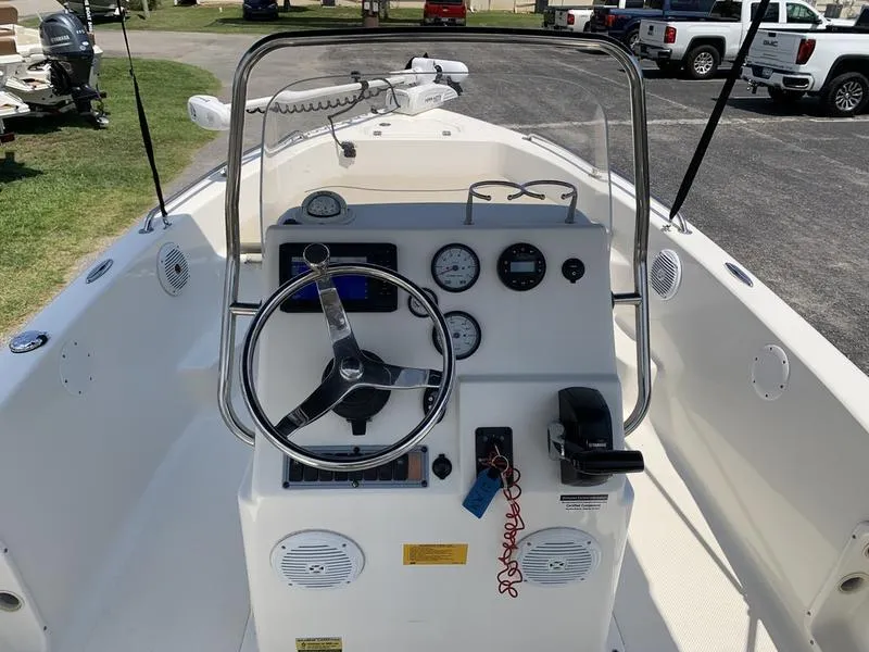 Slide: The Image of 2021 Key West 176cc boat dashboard with steering wheel and gauges. - 18