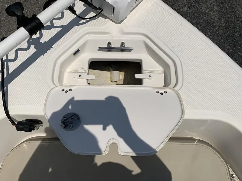 Slide: The Image of 2021 Key West 176cc boat storage compartment with open hatch and visible shadow. - 25