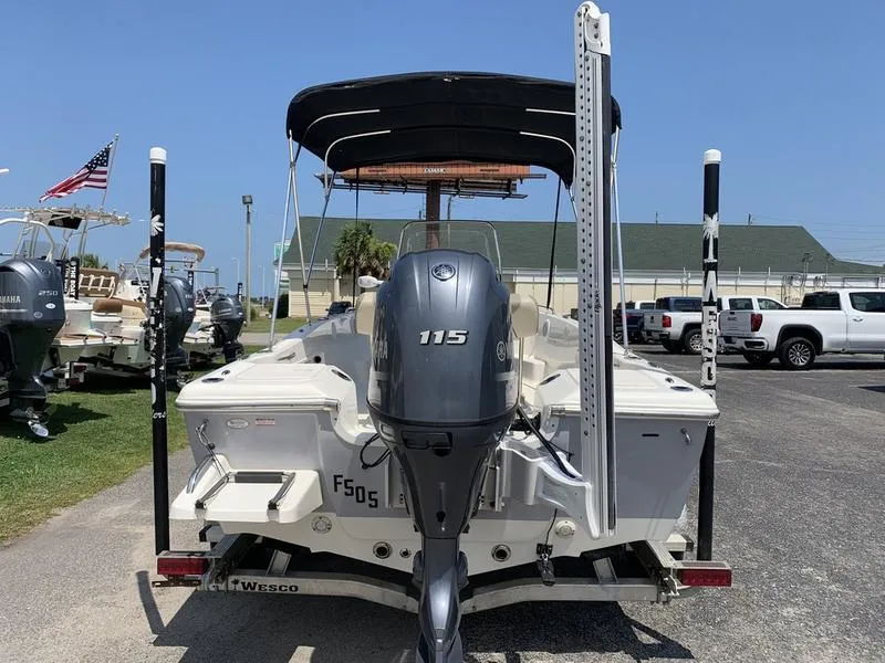 Slide: The Image of 2021 Key West 176cc boat with Yamaha 115 engine, parked outdoors. - 3