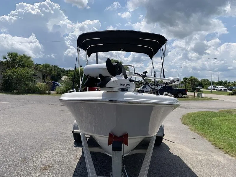 Slide: The Image of 2021 Key West 176cc boat with canopy and Minn Kota motor on a trailer. - 7