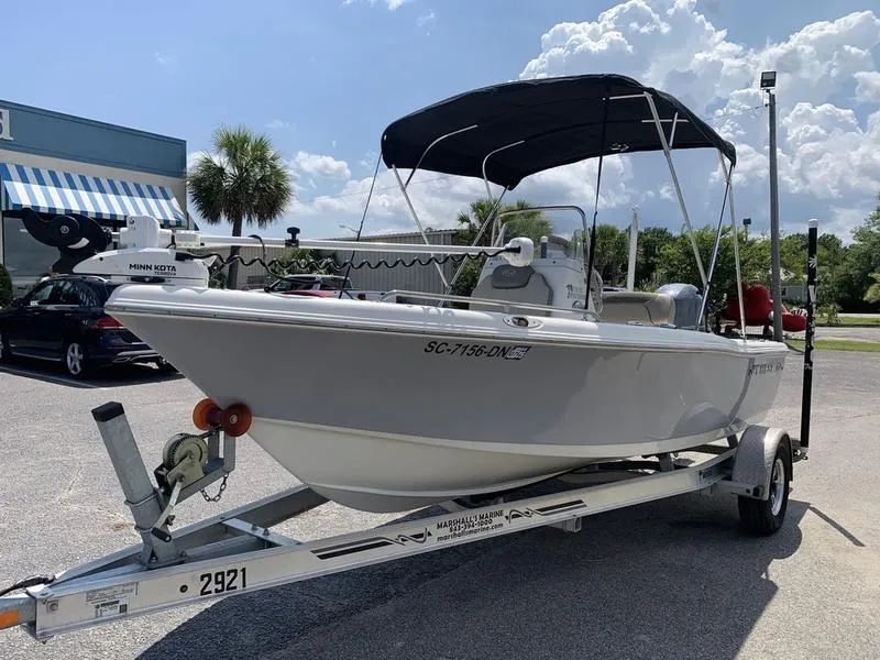 Slide: The Image of 2021 Key West 176cc boat on trailer with canopy, parked outdoors. - 8