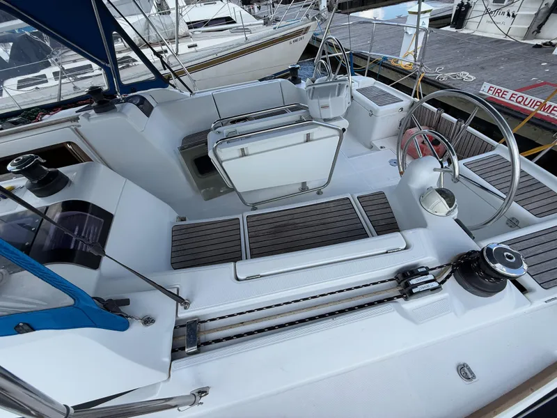 Slide: The Image of Cockpit of 2015 Jeanneau 409 sailboat with dual steering wheels and teak flooring. - 11