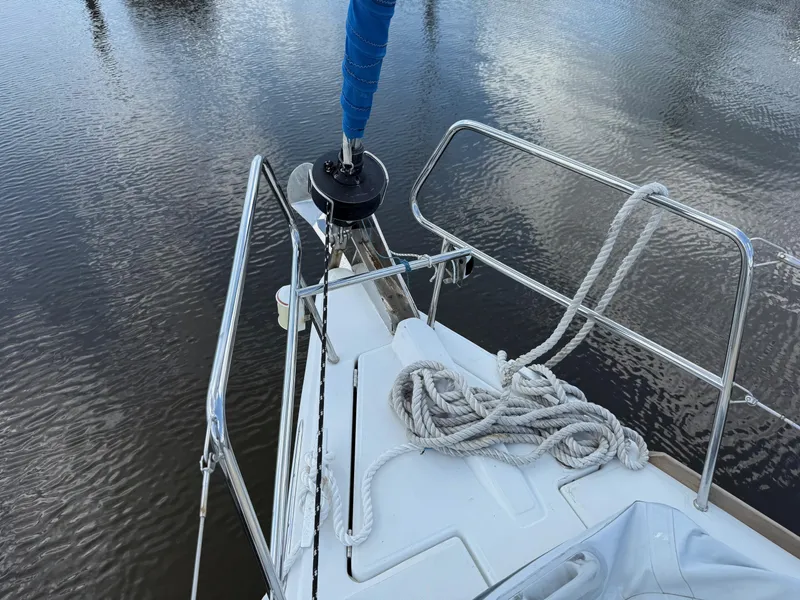 Slide: The Image of Bow of 2015 Jeanneau 409 sailboat with coiled rope and calm water. - 18