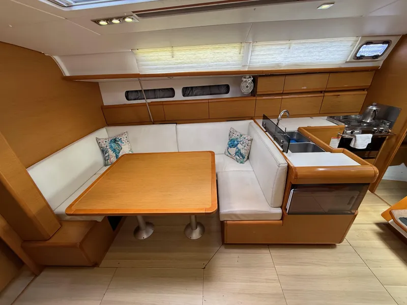 Slide: The Image of Interior of 2015 Jeanneau 409 yacht with wooden dining area and compact kitchen. - 21